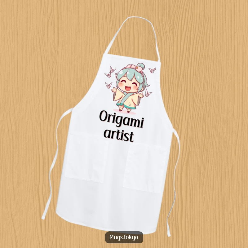 Funny apron showcasing a smiling character in a chef's hat, juggling miniature origami cranes, ideal for kitchen humor and protection.