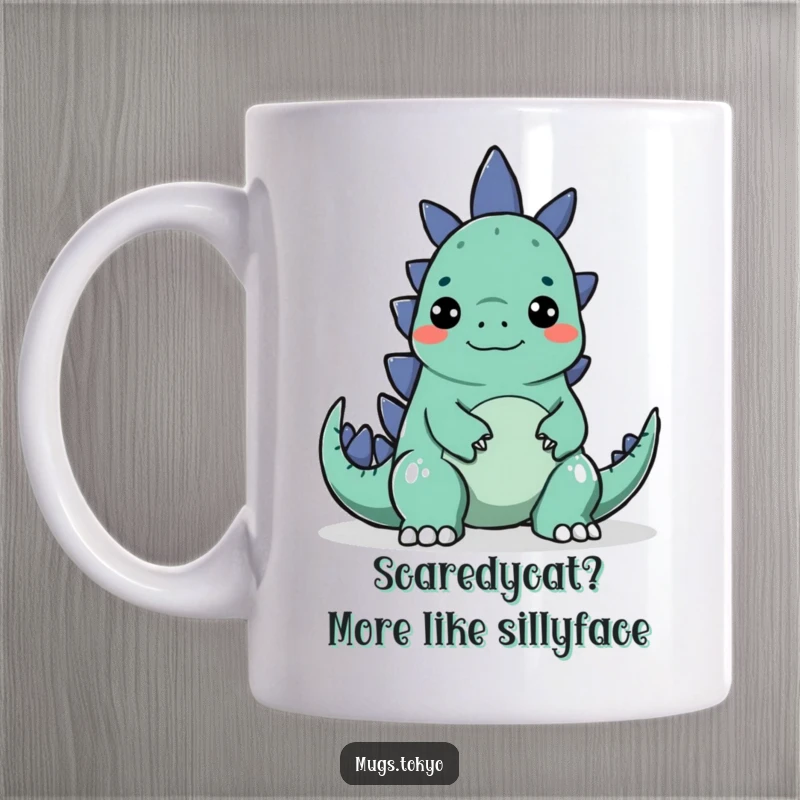 Funny mug showing a character making a silly face to playfully startle a small, cartoonish Godzilla.