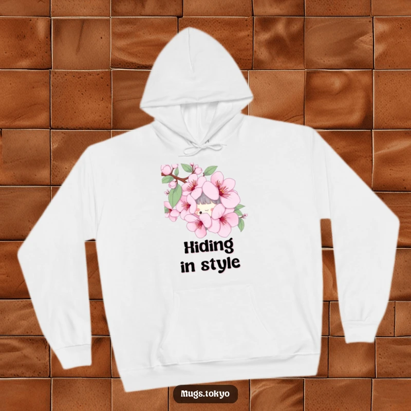 Funny hoodie with a playful character peeking from behind a stylized cherry blossom, offering cozy spring vibes.