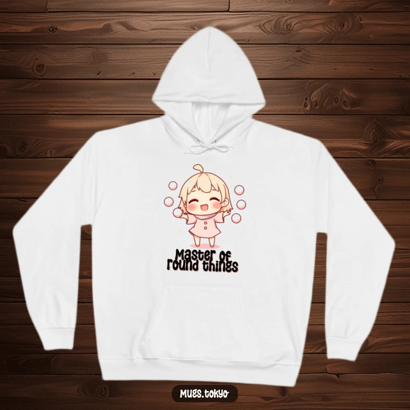 Funny hoodie showcasing a character expertly juggling round mochi balls, radiating happiness and warmth in a comfortable fit.